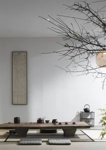 A modern tea room featuring wooden furniture and minimalist decor.