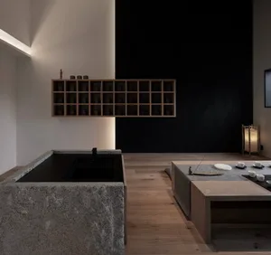 Minimalist design of a tea room featuring wooden seating and granite counters, showcasing clean lines and simplicity.