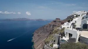 Residences overlooking the sea built into rocky cliffs.