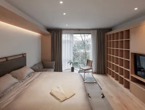 A minimalist bedroom featuring wood elements, a comfortable bed, and a large window.