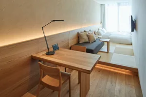 Minimalist bedroom featuring wooden furniture and a cozy atmosphere.