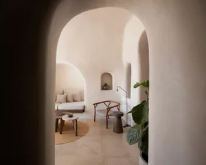 A minimalist interior space with neutral tones and a cozy ambiance.
