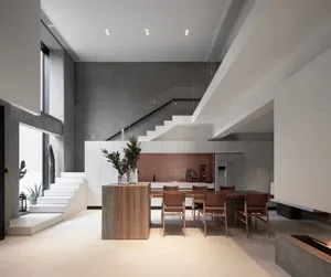 Modern minimalist kitchen with concrete finishes and natural wood accents.