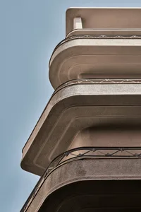 Curved concrete balconies on a modern building facade.