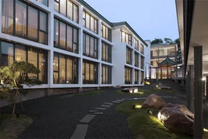 Modern building exterior with large glass windows and concrete walls