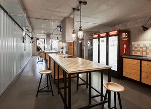 An industrial style cafeteria kitchen with metal, wood, and tile materials.