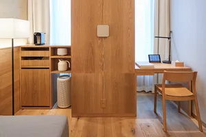 A modern minimalist residential interior with wooden furniture and clean lines.