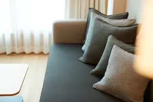 A neatly arranged display of fabric cushions on a sofa, emphasizing comfort and style.