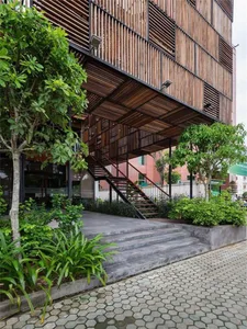 A modern industrial exterior with wooden shutters and metal railings.