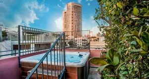 Modern rooftop hot tub and view of cityscape
