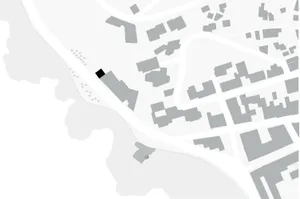 A grayscale city block plan showcasing a black building among other grey structures