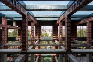 A modern interior with glass panels and concrete structures.