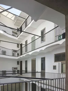 Modern interior design with glass and metal balconies.