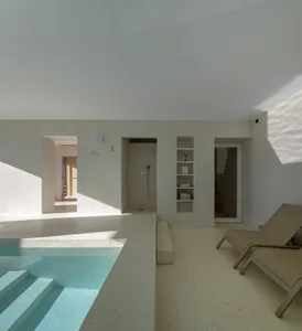 Modern minimalist swimming pool suite with concrete and terrazzo materials.