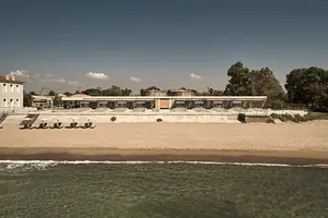 A modern beach resort constructed with concrete on the shoreline.