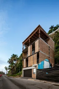 Modern residential architecture featuring wood, concrete, and glass materials.