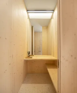 Modern wooden closet with a minimalist design and integrated desk area.