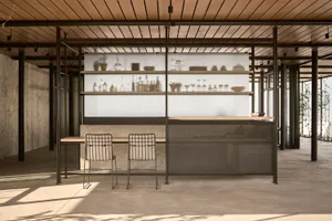 Industrial-style bar area with wooden elements and shelves.