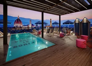 Modern rooftop pool with wooden deck and cityscape view