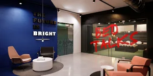 A minimalist lobby featuring concrete walls and furniture with a contemporary design.