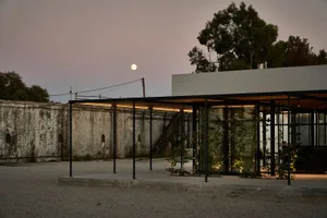 A minimalist residential structure with a concrete facade and a modern architectural design.