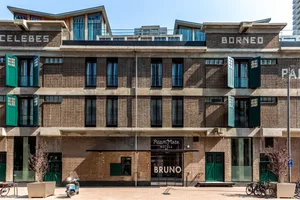 Bruno RoomMate Hotel features a modern design with brick and concrete exterior materials.