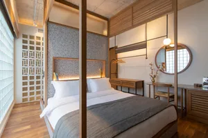 Modern bedroom with wooden features and a bed.