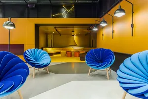 A modern industrial office space featuring textured fabric and concrete materials.
