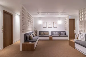 A living room with modern furniture, neutral color palette, and minimalist decor.
