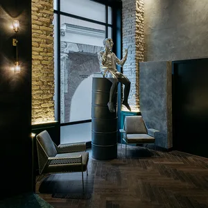 Metal statue in an industrial-style lobby with metal, stone, and glass materials