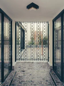 Modern entrance with a geometric metal mesh design.