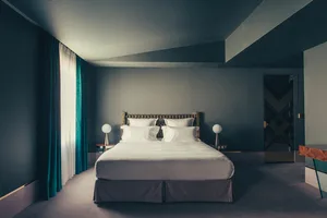 A minimalist bedroom featuring neutral tones and a modern design.