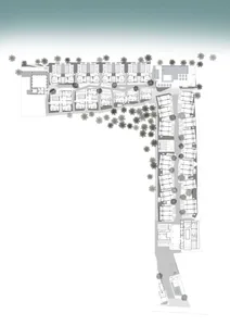 Floor plan of a residential development featuring multiple buildings with various layouts and trees.