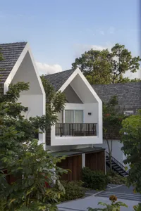 Modern residential home with white stucco exterior and grass