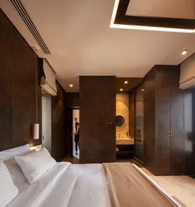 A modern bedroom featuring metallic-textured walls and a minimalist design.
