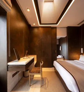 A modern bedroom with metallic-textured walls and a minimalist design.