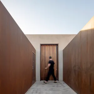 A modern architectural entryway featuring a metal door.