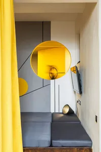 Modern living space with minimalist furniture, yellow lighting, and a sleek, open design.
