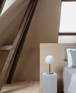 Minimalist bedroom featuring wooden beams and a sleek, modern design.