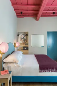 A minimalist bedroom with a wooden structure and metal accents.