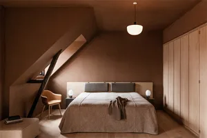 A minimalist bedroom with wooden walls, a large bed, and a wooden armchair.
