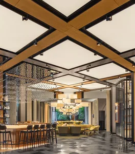 A modern hotel lobby featuring a wooden ceiling design and seating area.
