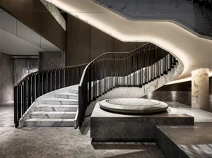 A modern staircase with marble steps and railings.
