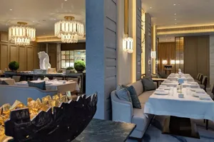 Modern restaurant interior with marble accents and elegant lighting.
