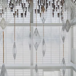 Modern, minimalist space featuring hanging umbrellas made of wood.