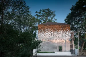 A modern house exterior featuring metallic mosaic shingles.