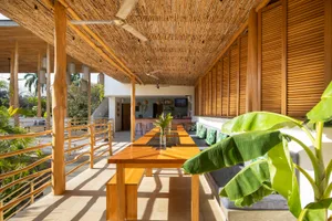Modern minimalist restaurant veranda with wooden elements and lush green plants