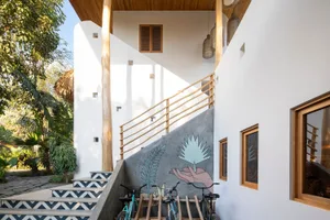 Concrete stairs with wooden handrails and tile accents.