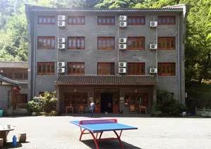A two-story brick building with wooden windows and air conditioning units.