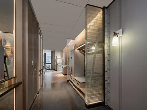A modern living room features metallic glass and brick storage solutions.